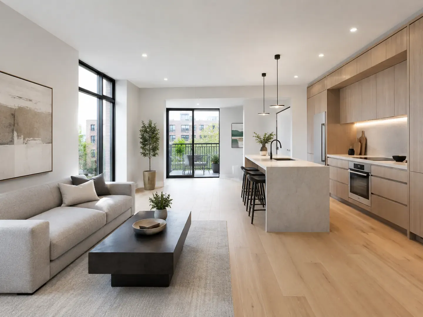 Bright renovated Toronto condo with a waterfall island, open dining area, and balcony doors