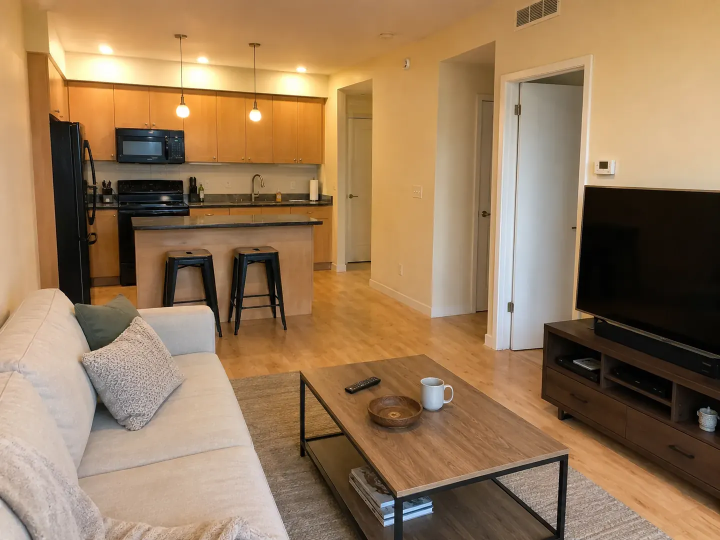 Before: a dated condo interior with oak cabinets, beige walls, and a closed galley kitchen